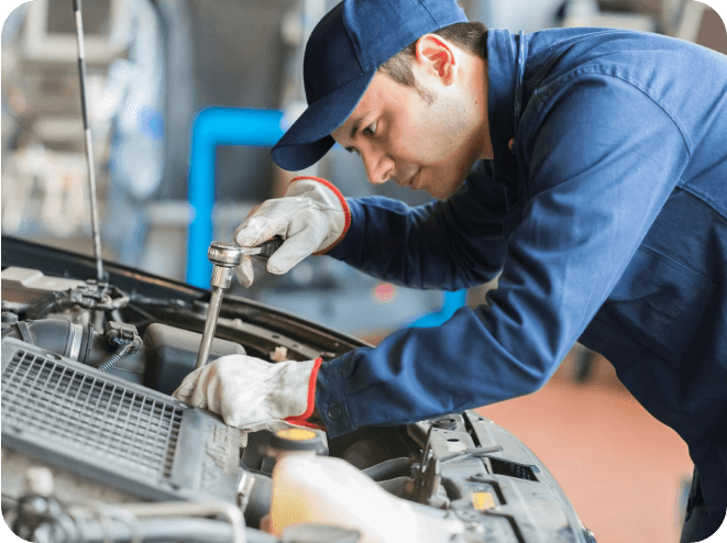 A man working on the hood of an automobile.